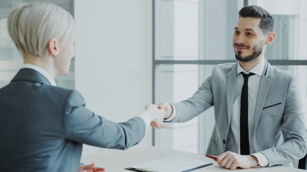 🎬 FULL 4K VIDEO for this still is in my bio link! ⬇️ HR male manager shaking hand to female candidate after having job interview in modern office indoors